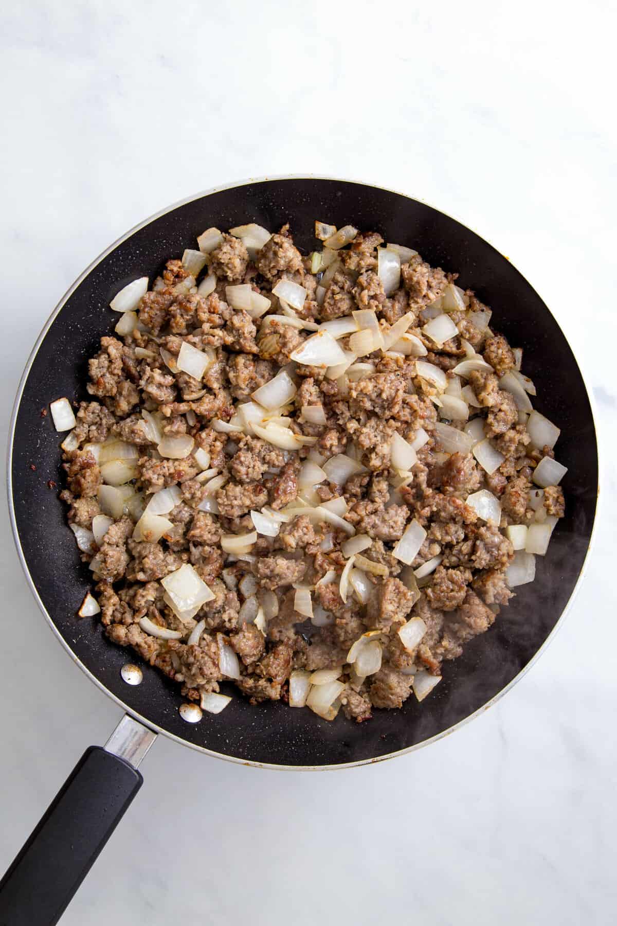 onion and ground pork cooked in a pan