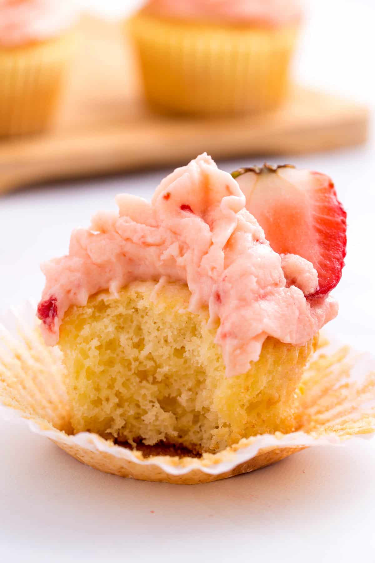 bite taken out of a strawberry lemon cupcake
