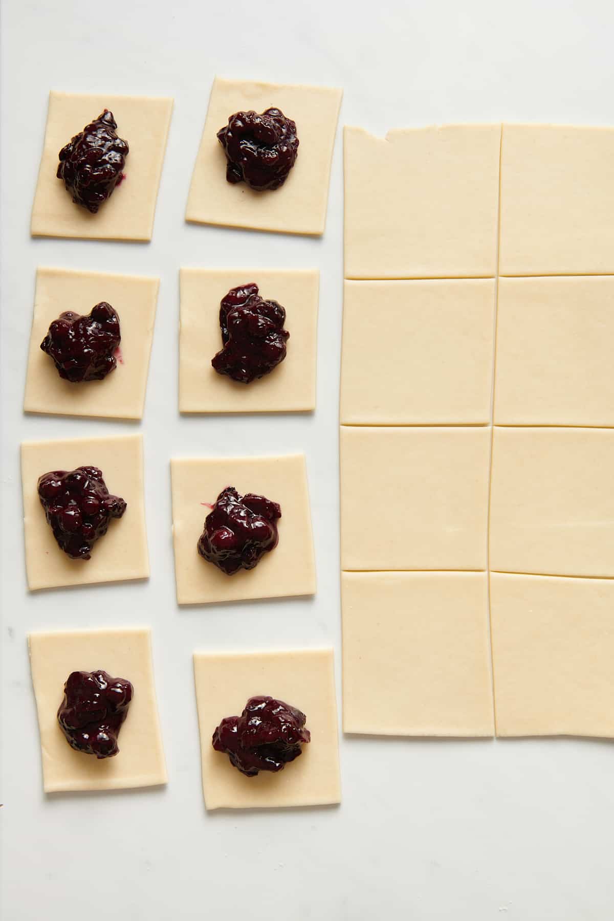 pastry dough squares with blueberry pie filling