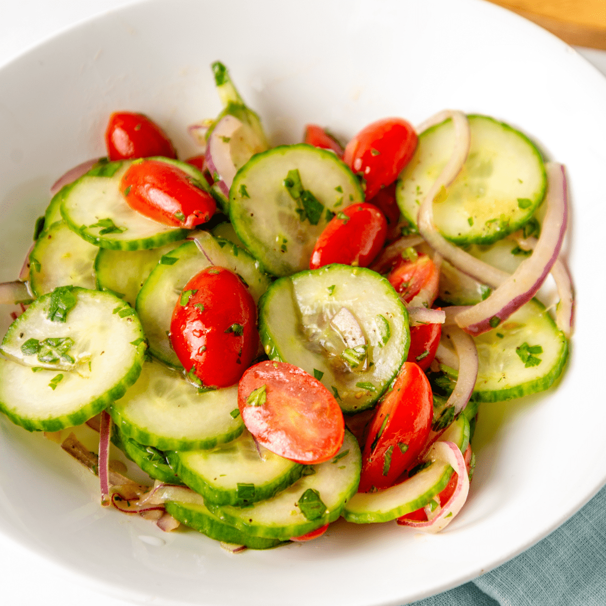 A bowl of cucumber and tomato salad.