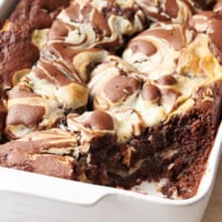 A baking dish full of earthquake cake with the corner slice missing.