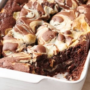 A baking dish full of earthquake cake with the corner slice missing.