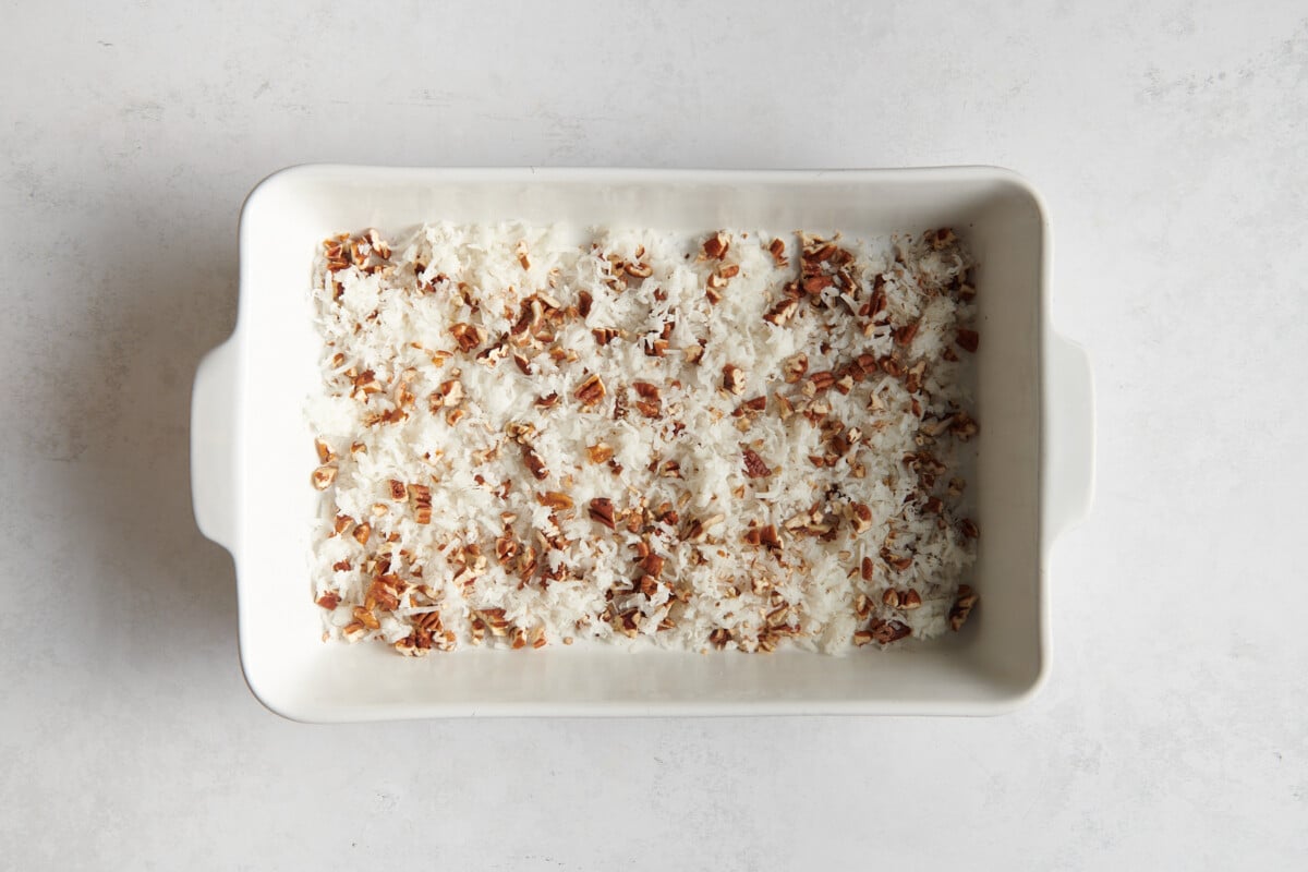Coconut and pecans in baking dish.