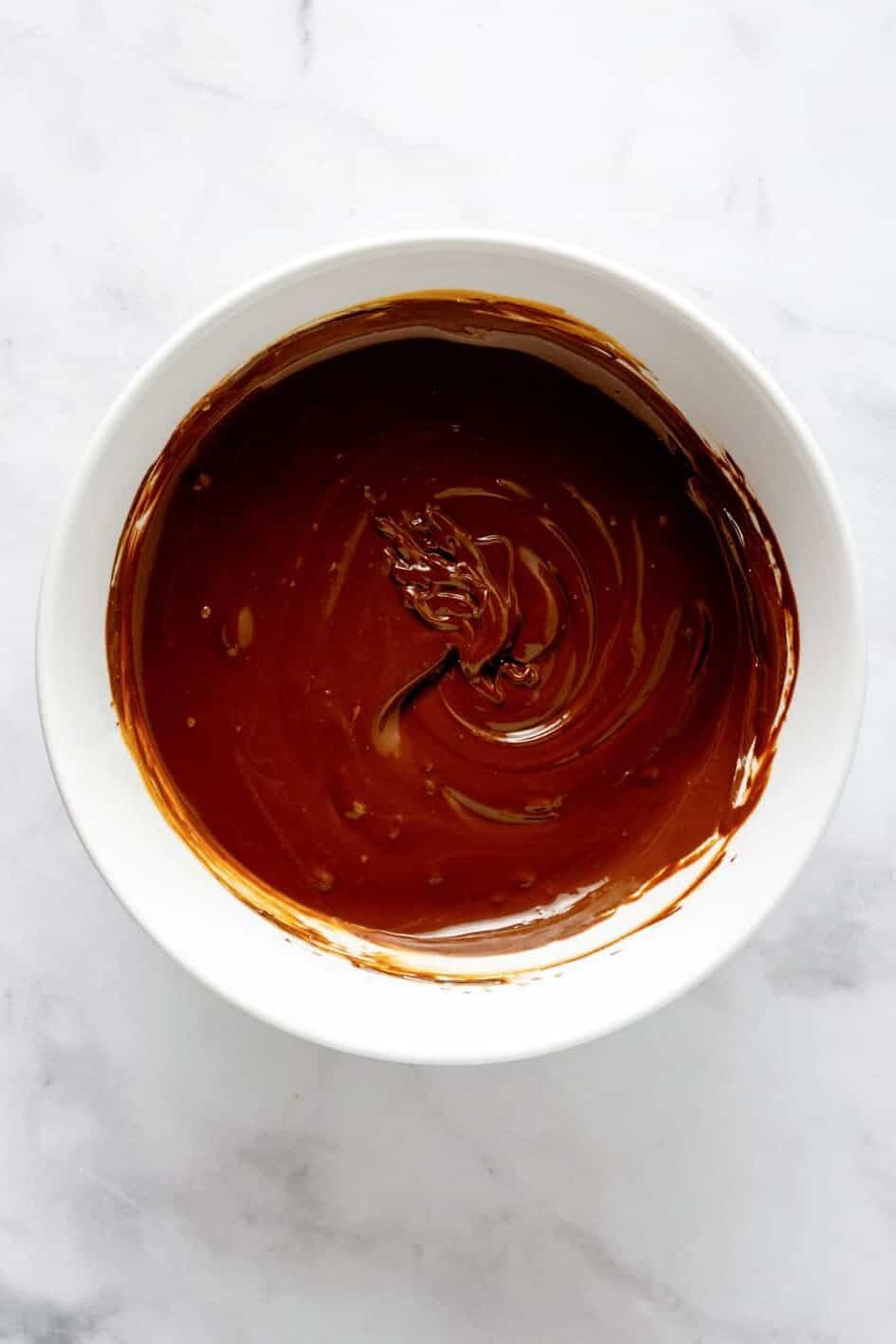 melted semi-chocolate in a white round bowl