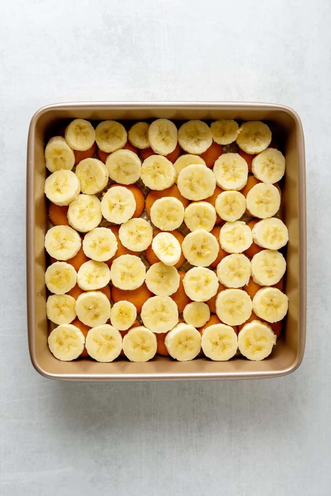 sliced bananas and nilla wafers layered in an 8x8 pan