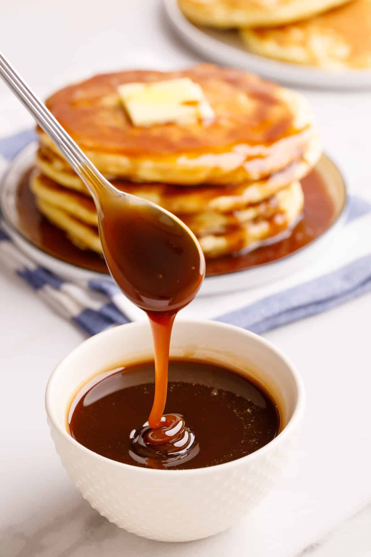 close up image of a bowl and spoon with homemade pancake syrup