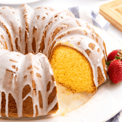 Pound cake topped with a glaze with a slice missing.