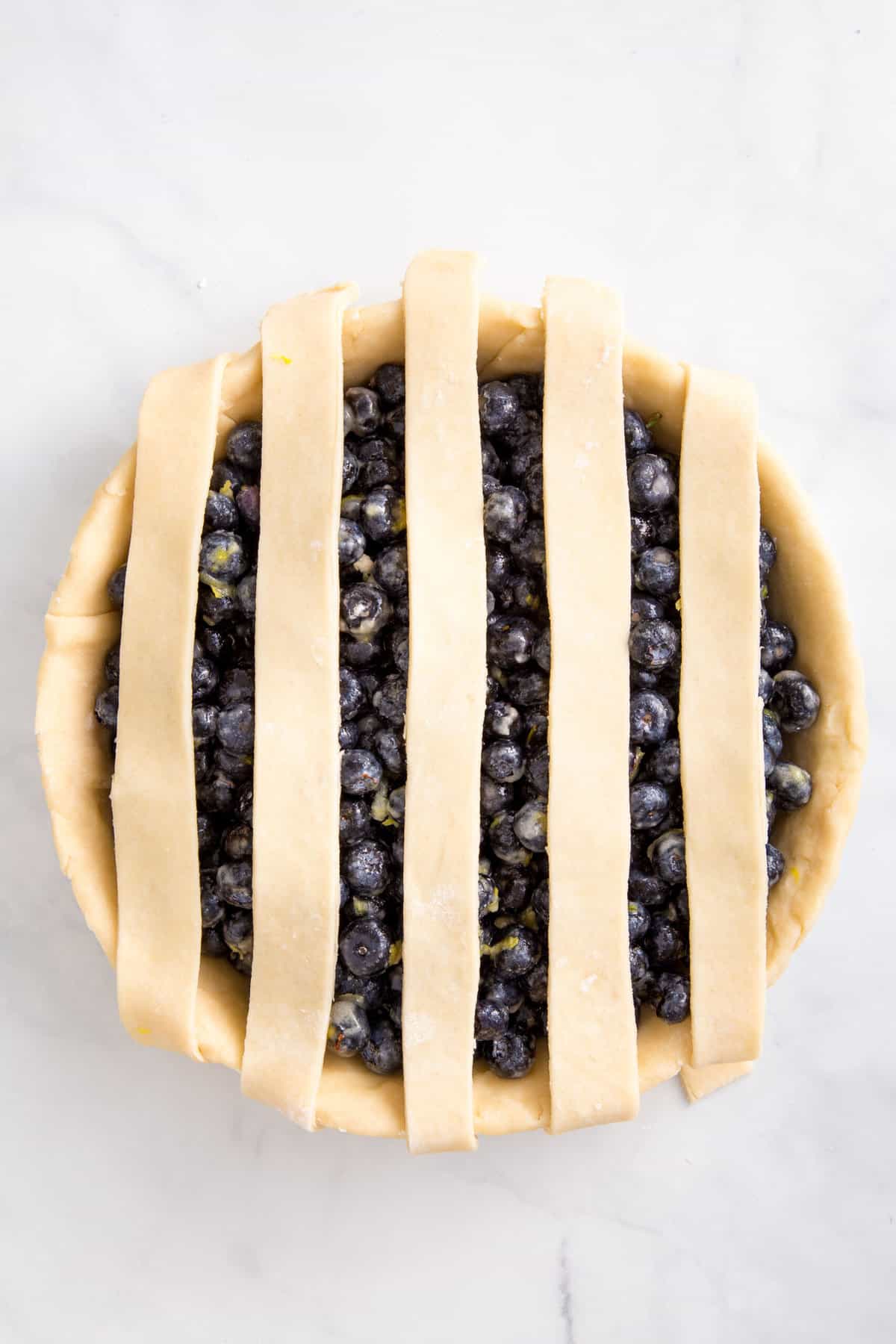 vertical pie dough design on a blueberry pie