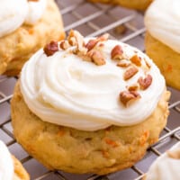 Frosted carrot cake cookies on a wire rack.