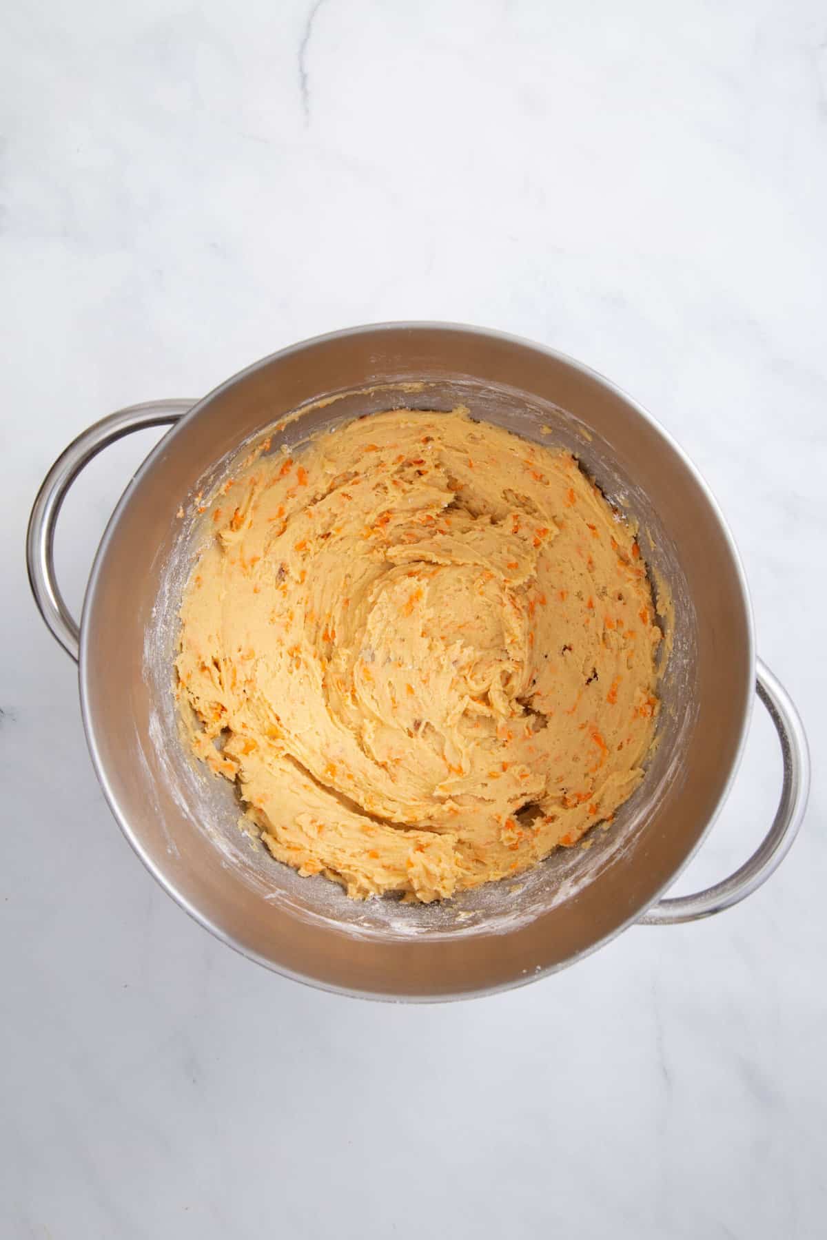 carrot cake cookie batter in a stainless steel mixer