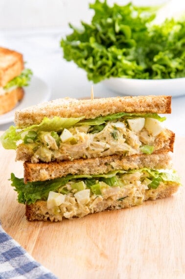 Two halves of a chick-fil-a chicken salad sandwich on top of each other.