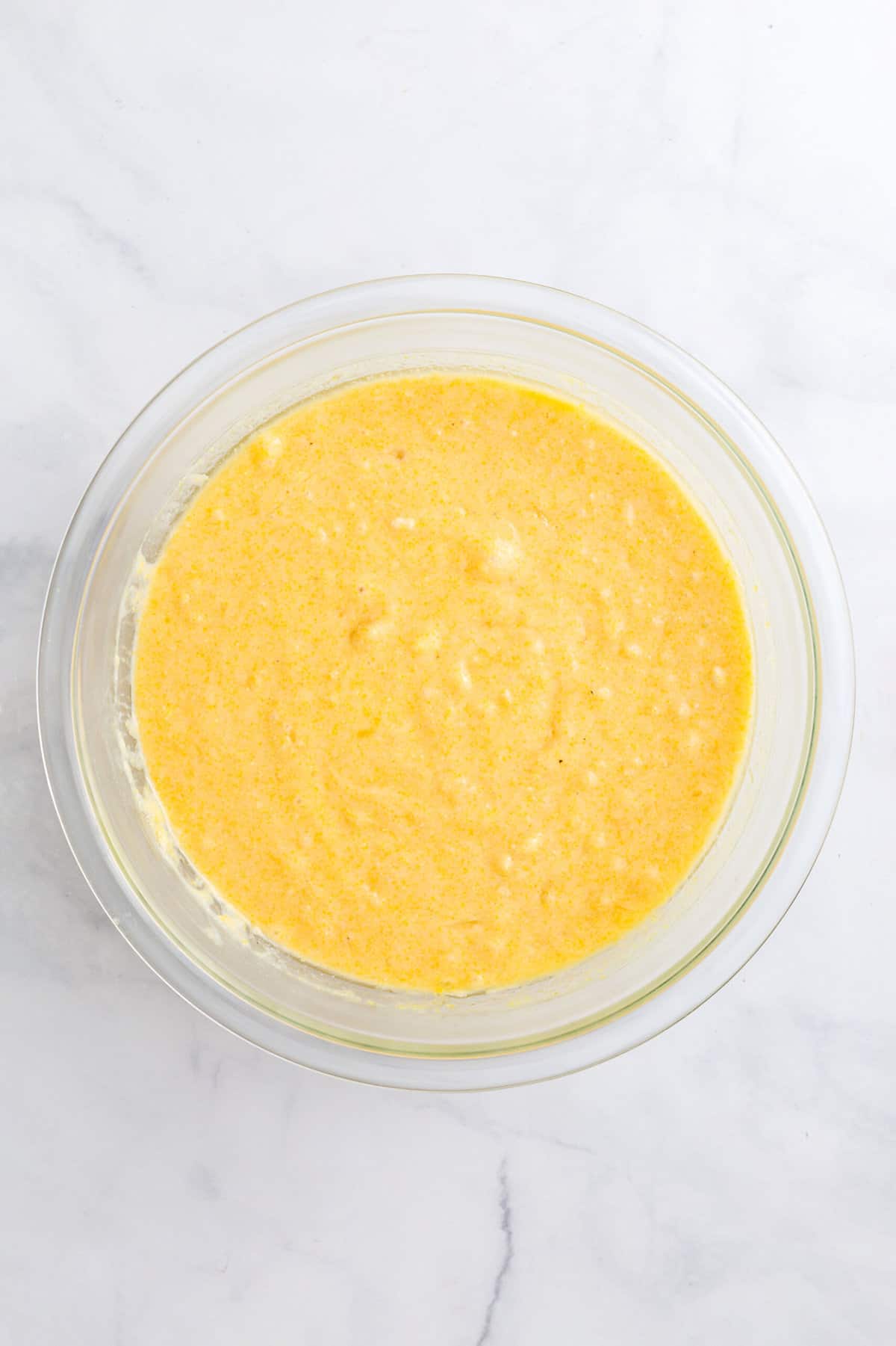 homemade corn muffin batter in a large glass bowl
