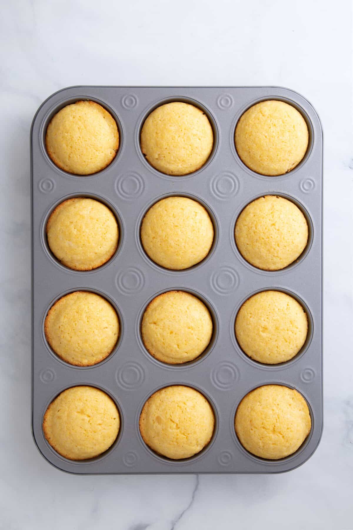 baked corn muffin in a 12 count muffin tin.