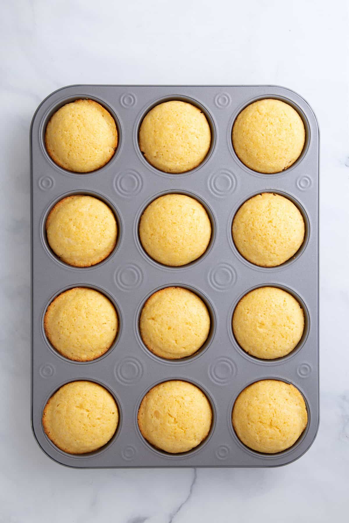 baked corn muffin in a 12 count muffin tin