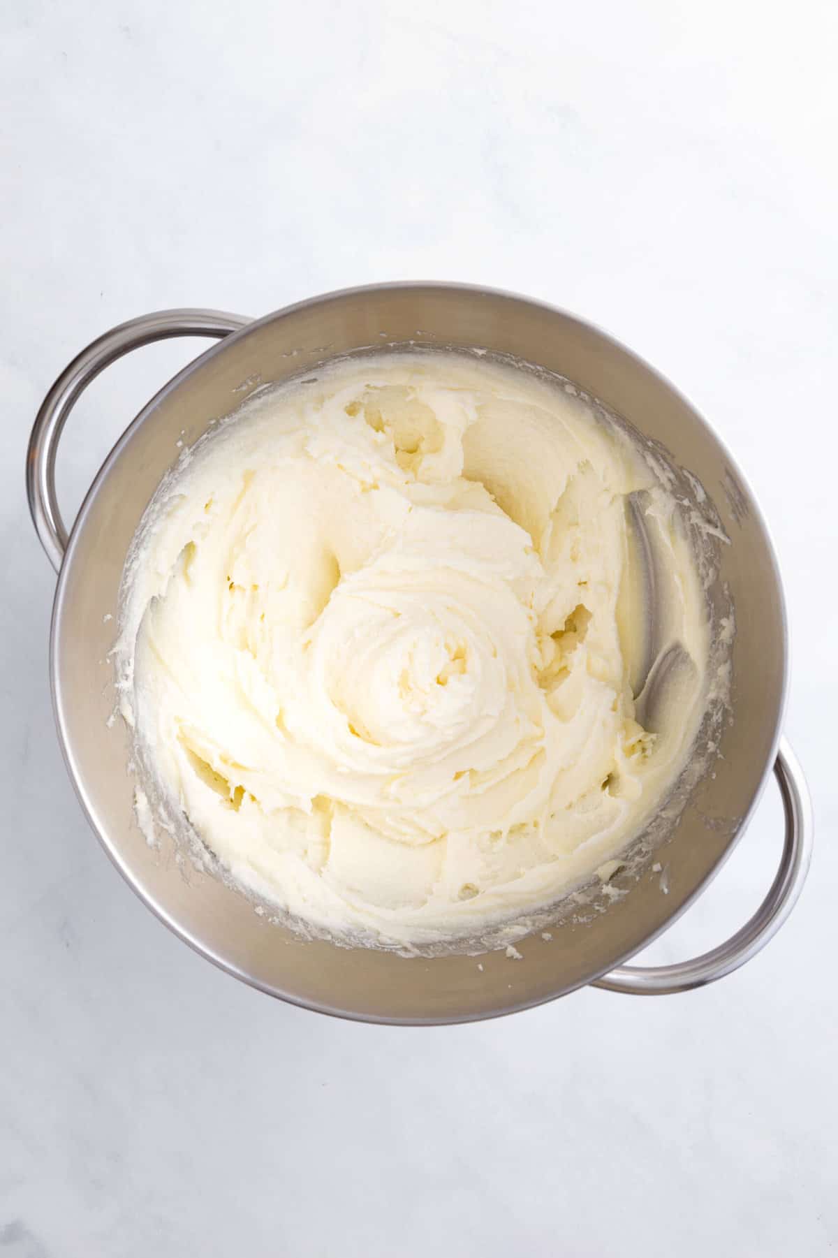 cream cheese pound cake ingredients in a stainless steel mixing bowl