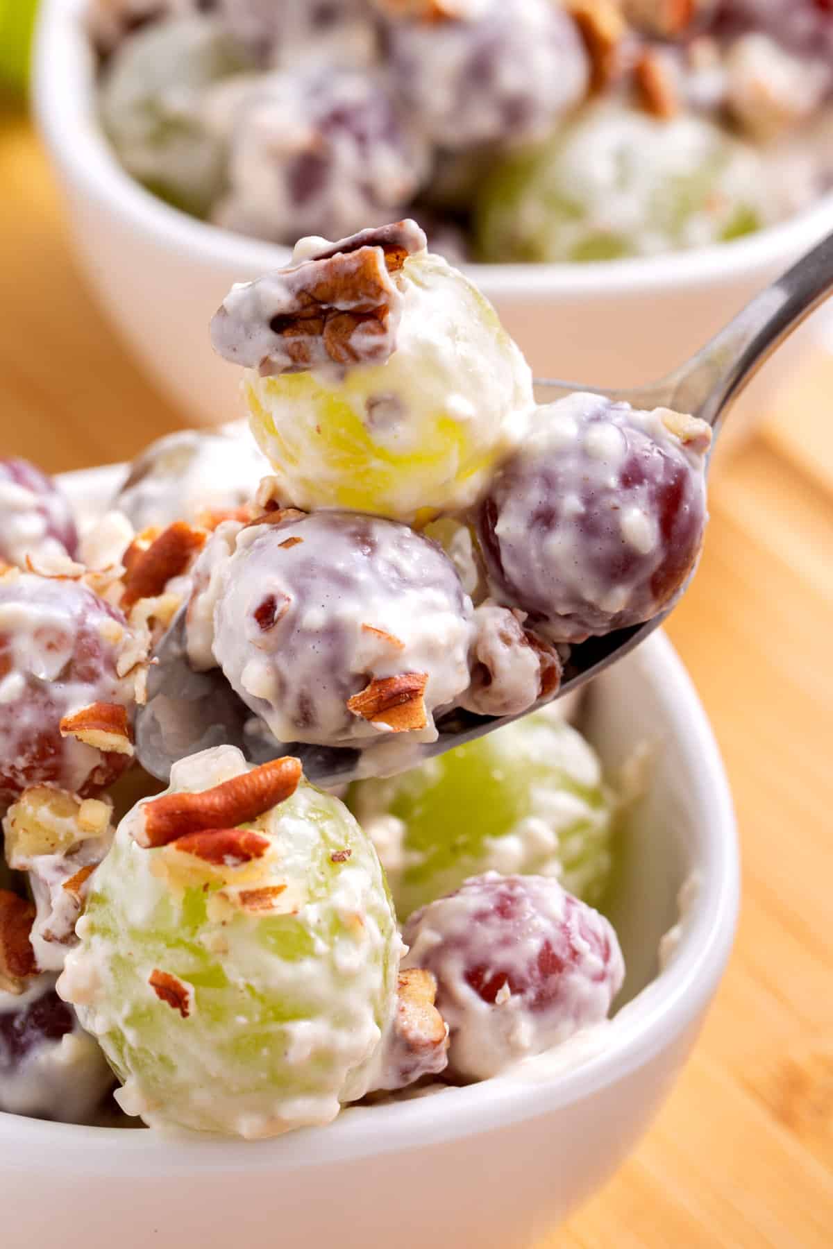 close up image of a spoonful of grape salad