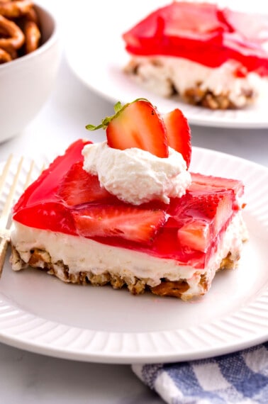 A square of strawberry pretzel salad on a plate.