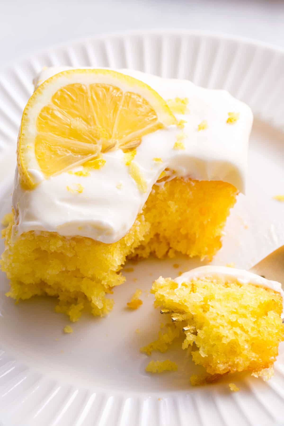 serving of lemonade cake sitting on a white round plate