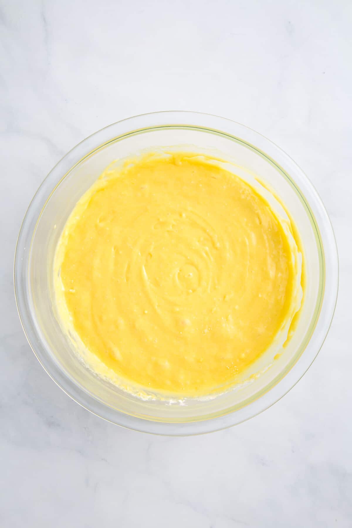 lemonade cake batter sitting in a large glass bowl.