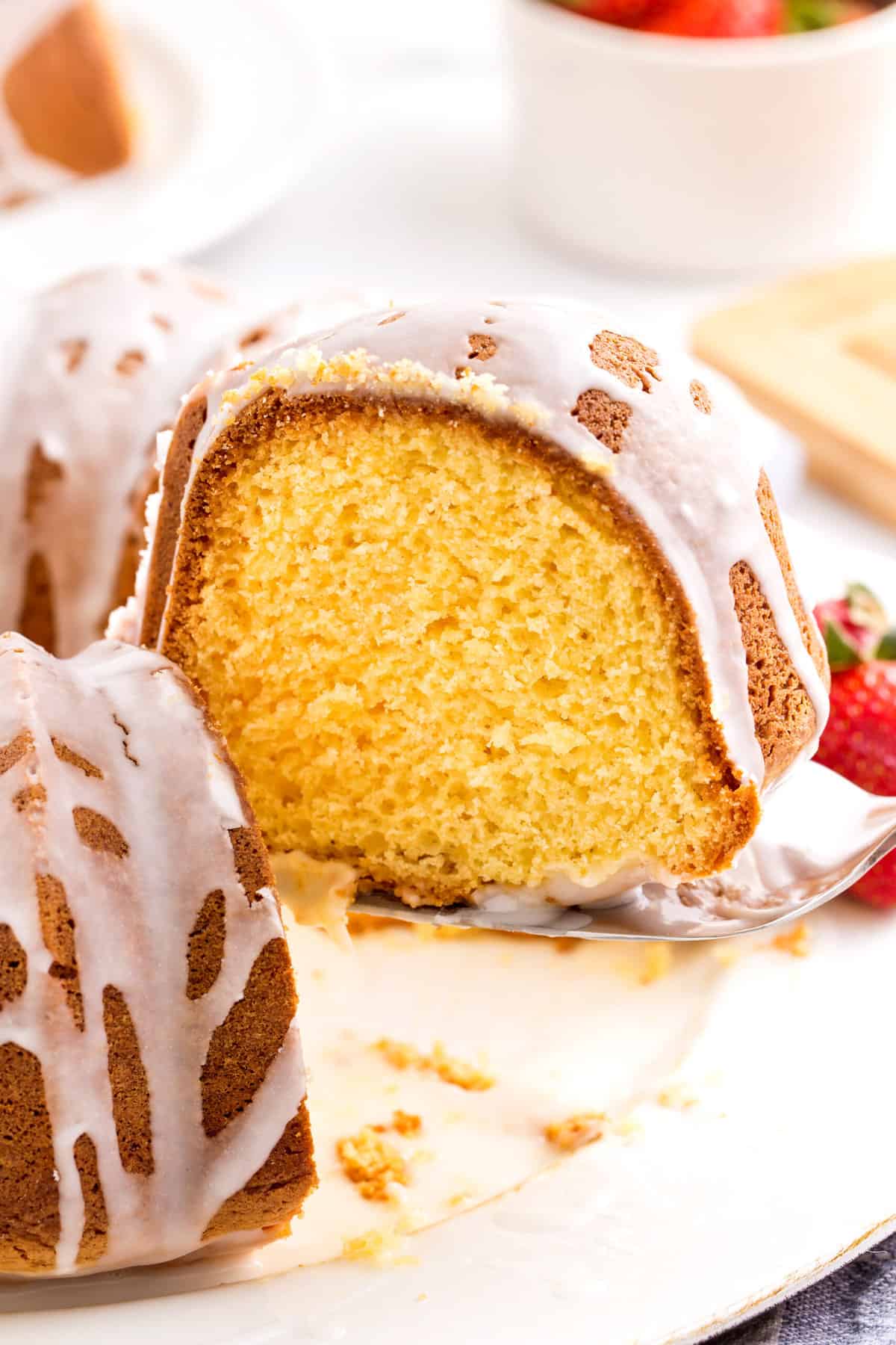slice of cake mix pound cake sitting on a metal cake spatula and showing the cross section