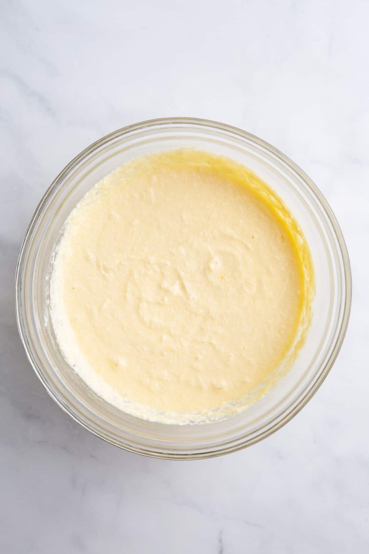 cake mix pound cake batter in a large glass bowl.