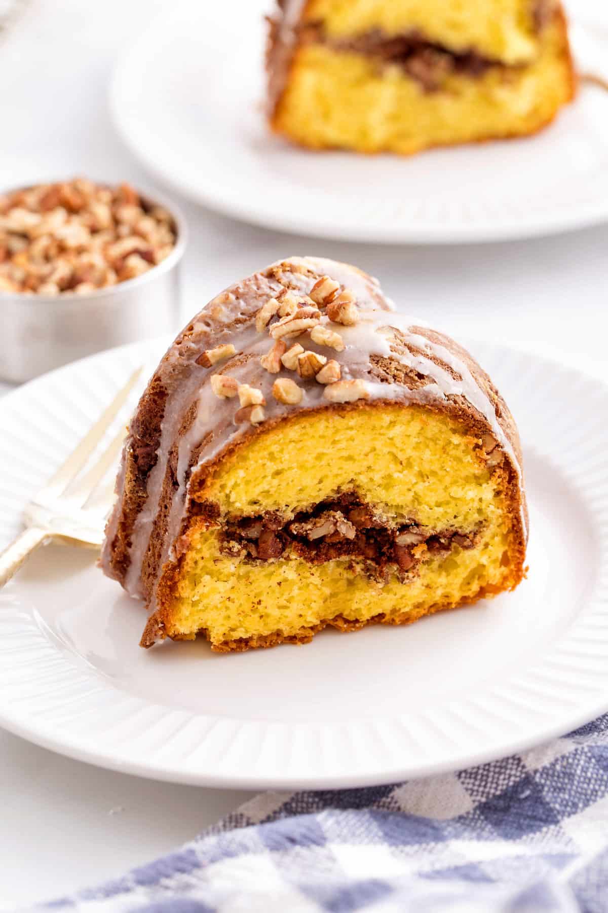 slice of sock it to me cake sitting on a white round plate.