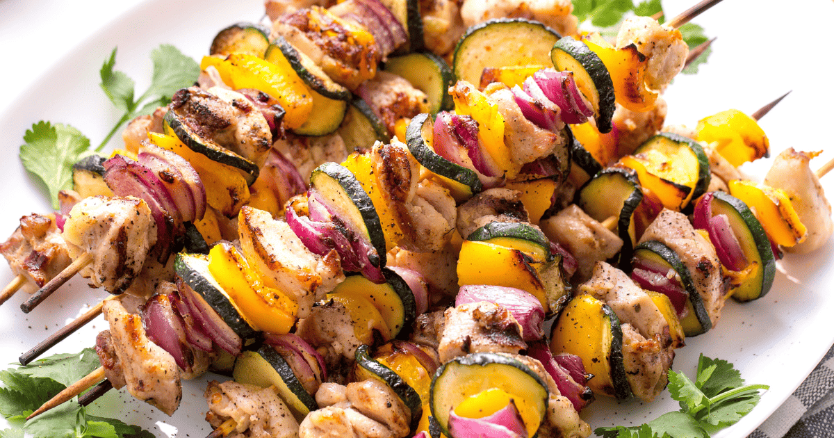 Grilled chicken kabobs on a plate. 