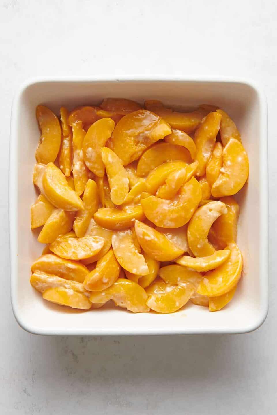 canned sliced peaches in an 8x8 baking dish