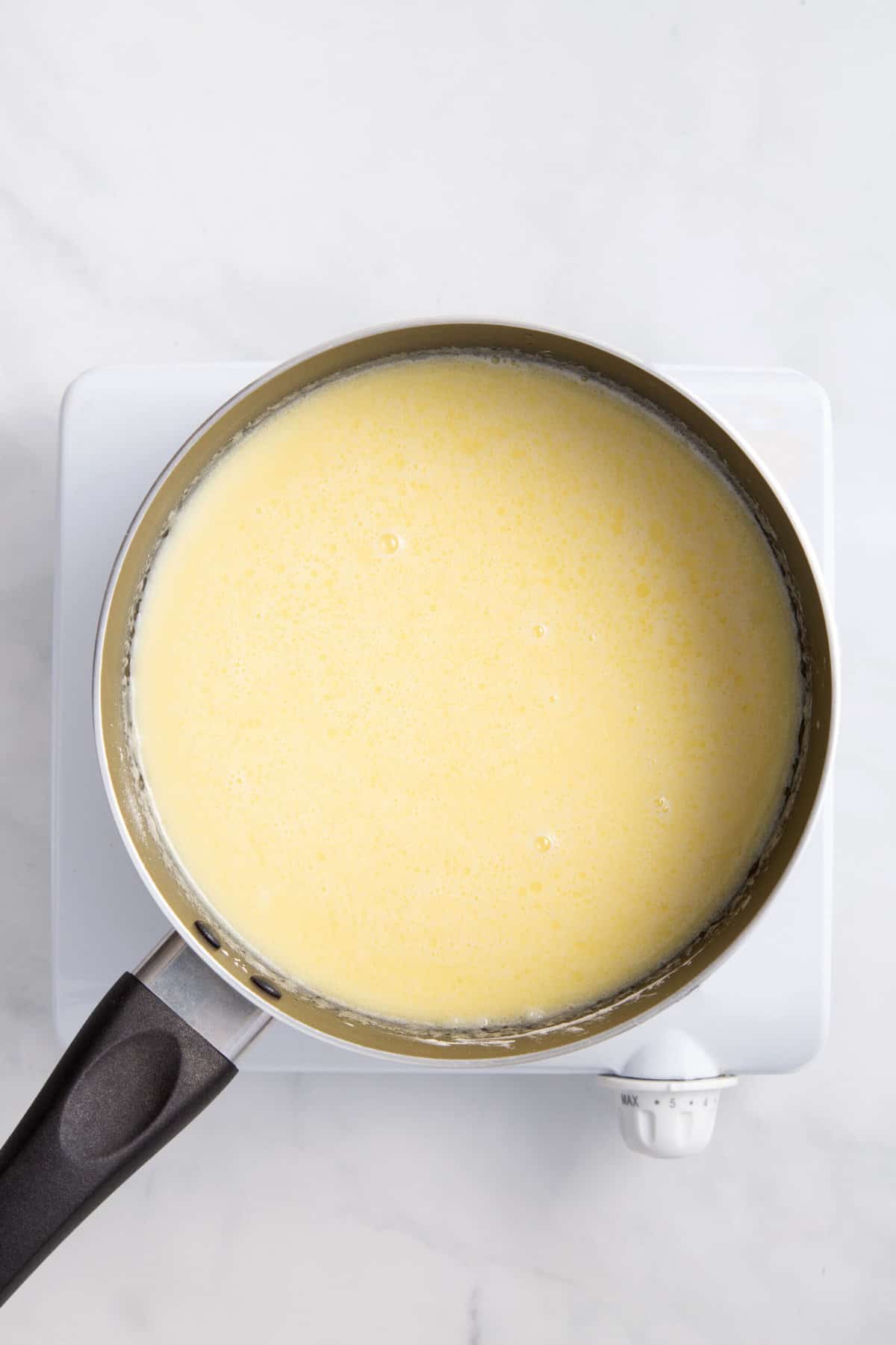 custard pie filling in a stainless steel saucepan