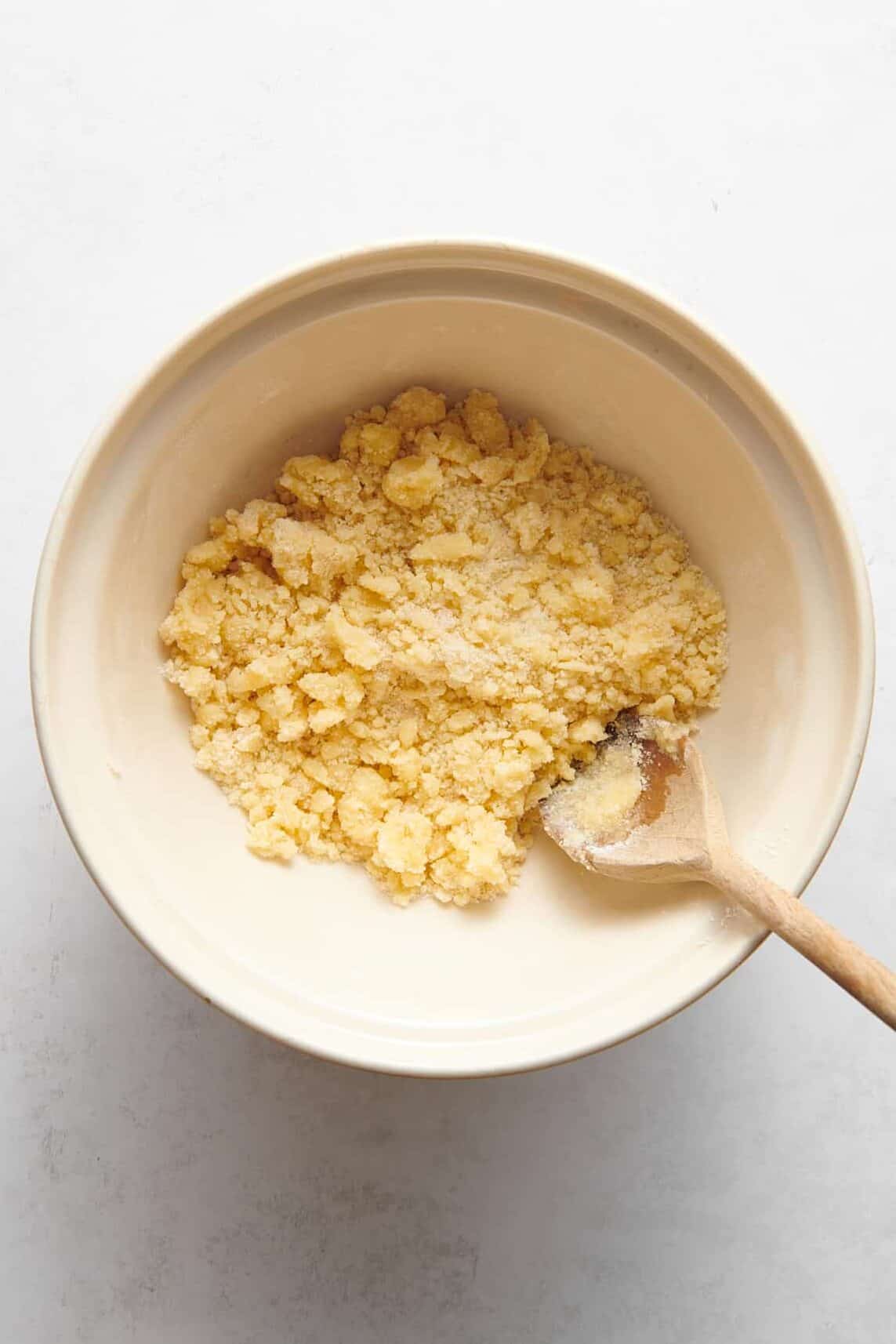 blackberry cobbler crumble topping sitting in a ceramic mixing bowl