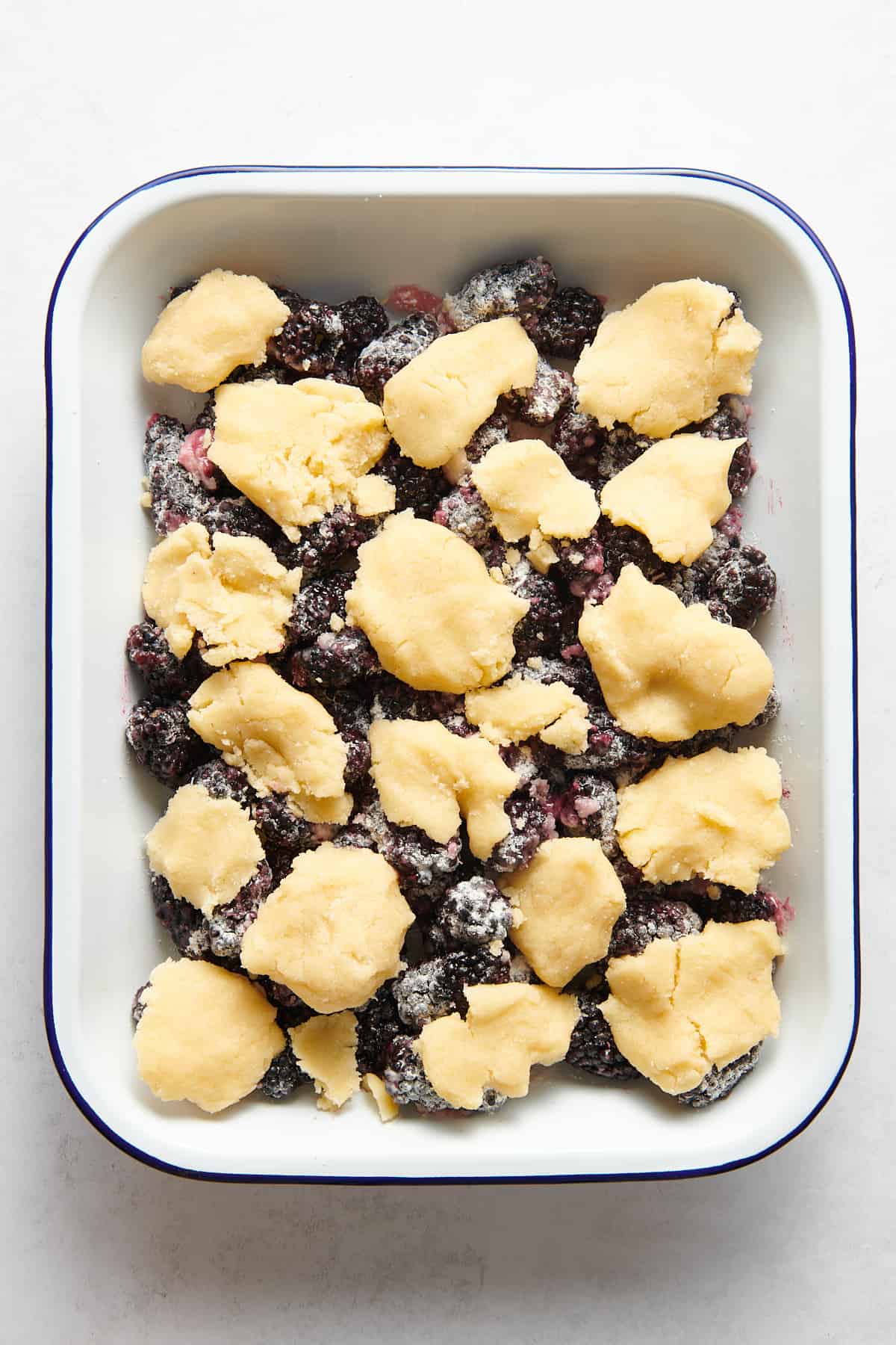blackberry cobbler prepared in a 9x13 pan and ready to bake