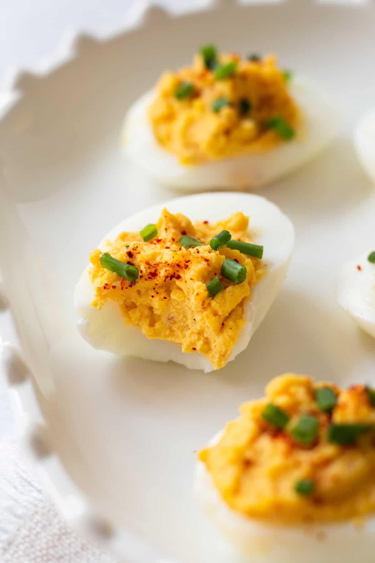 close up image of a bitten in half classic deviled egg