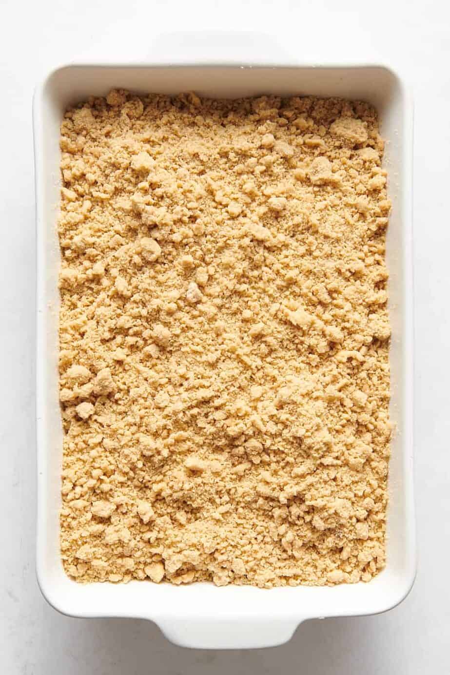9x13 casserole dish of peach crumble topping mixture