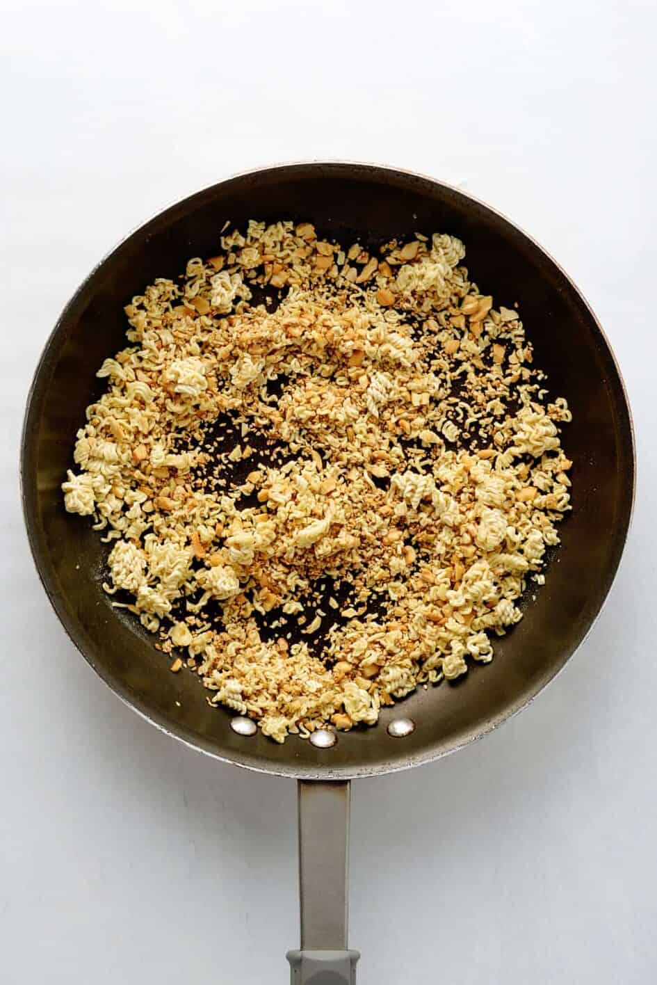 skillet of toasted crushed up ramen noodles