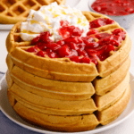 A stack of sourdough waffles on a plate.