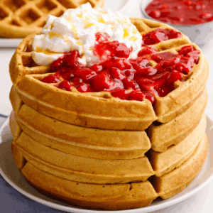 A stack of sourdough waffles on a plate.