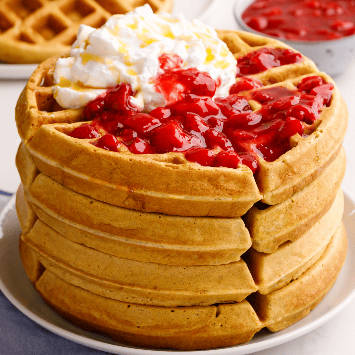 A stack of sourdough waffles on a plate.