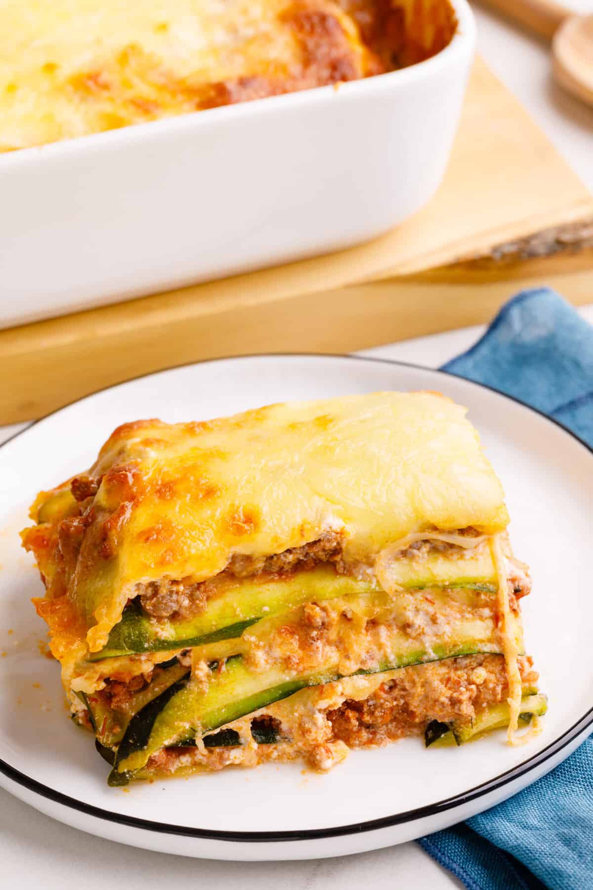 serving of zucchini lasagna sitting on a white round plate