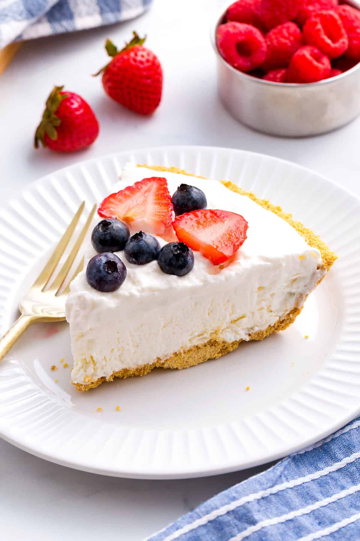 slice of cool whip pie served on a white round plate with a gold fork
