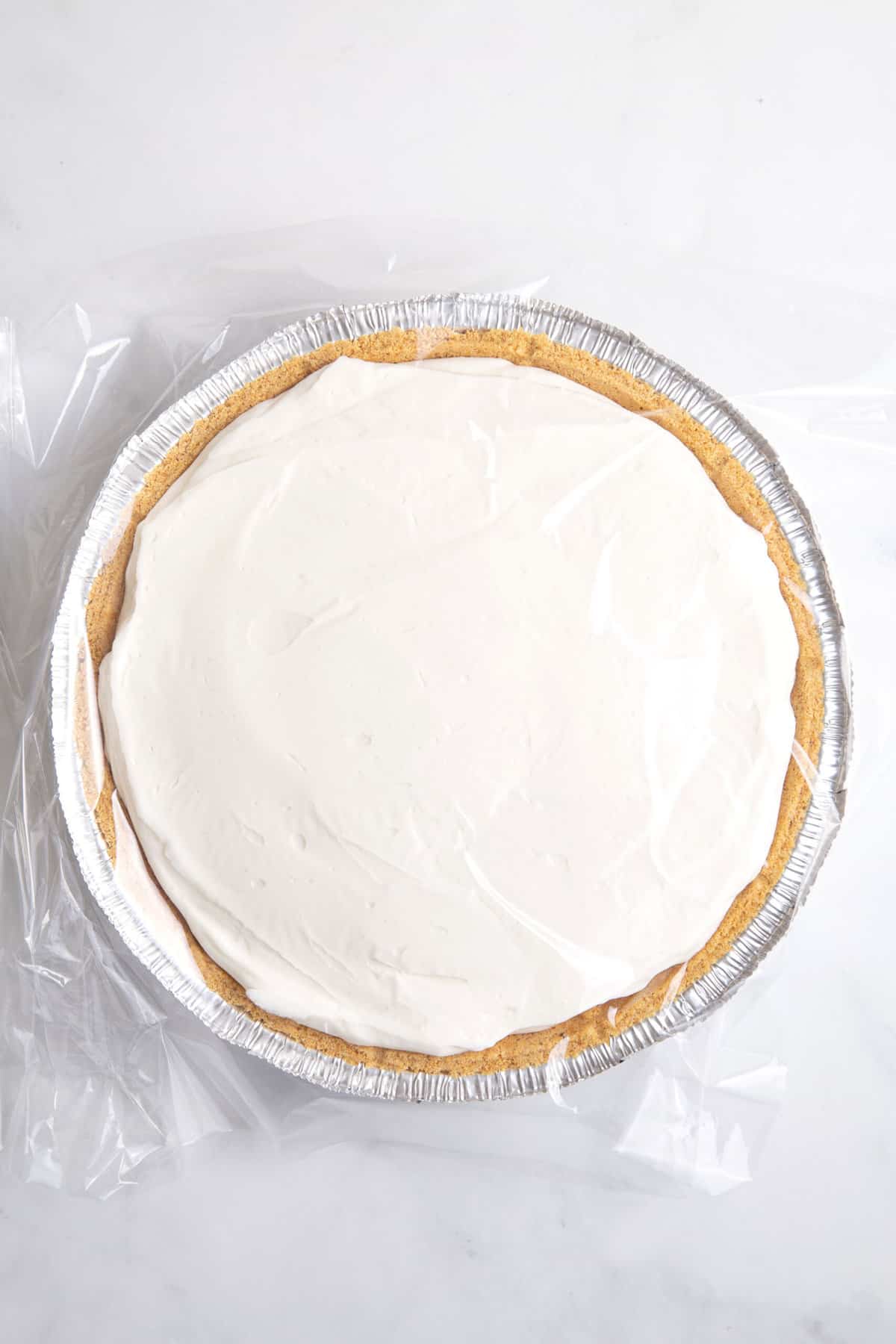 cool whip pie with plastic wrap on top