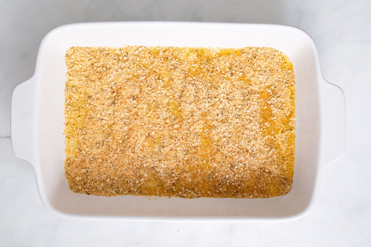Breadcrumb and Parmesan mixture in bottom of baking pan.