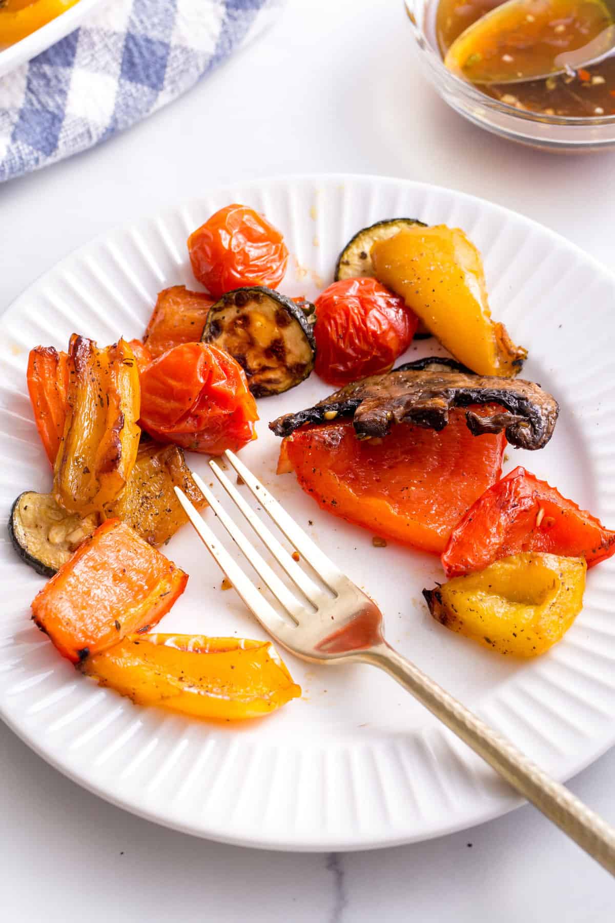plate of grilled vegetables with a gold fork
