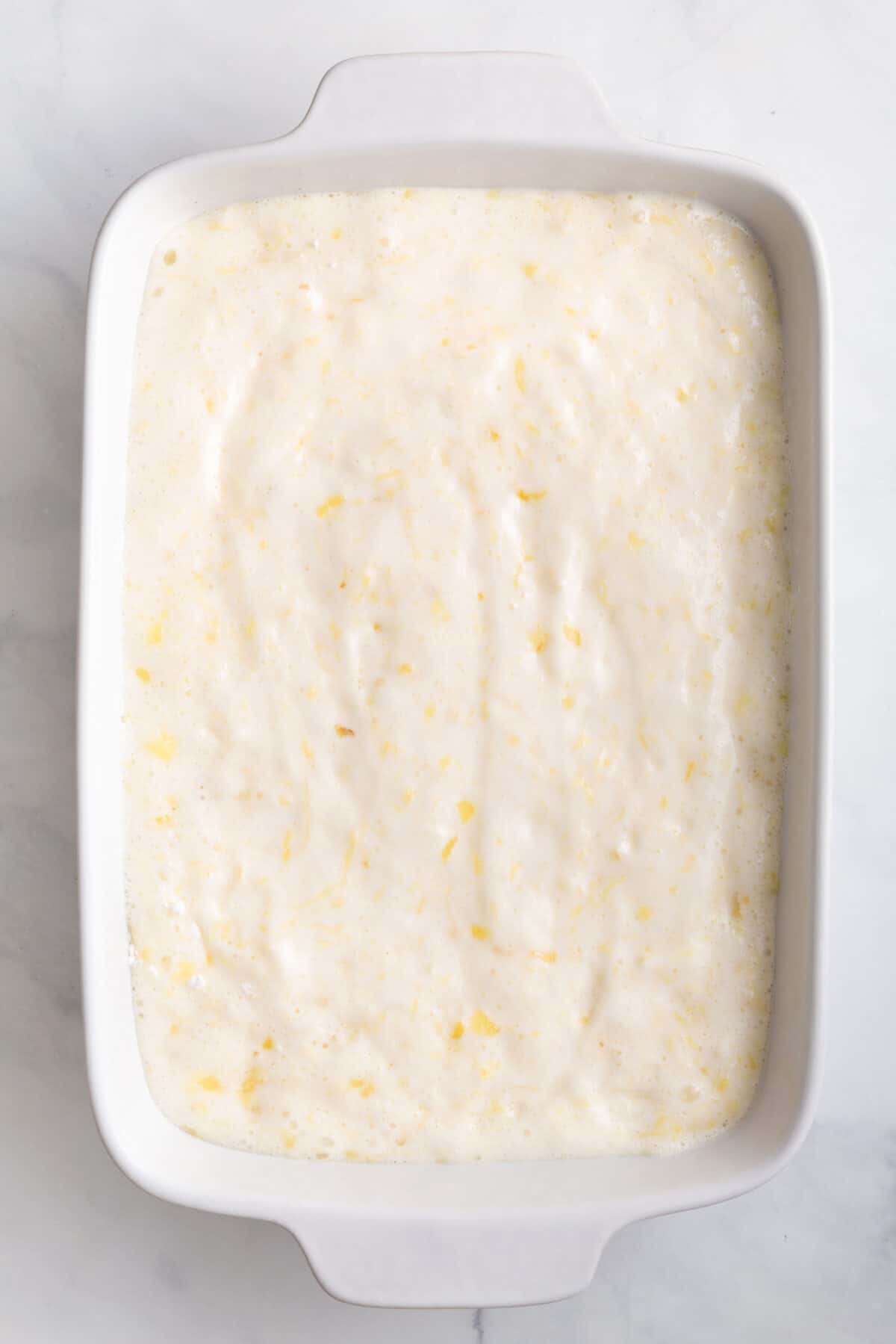 pineapple angel food cake batter sitting in a 9x13 baking dish
