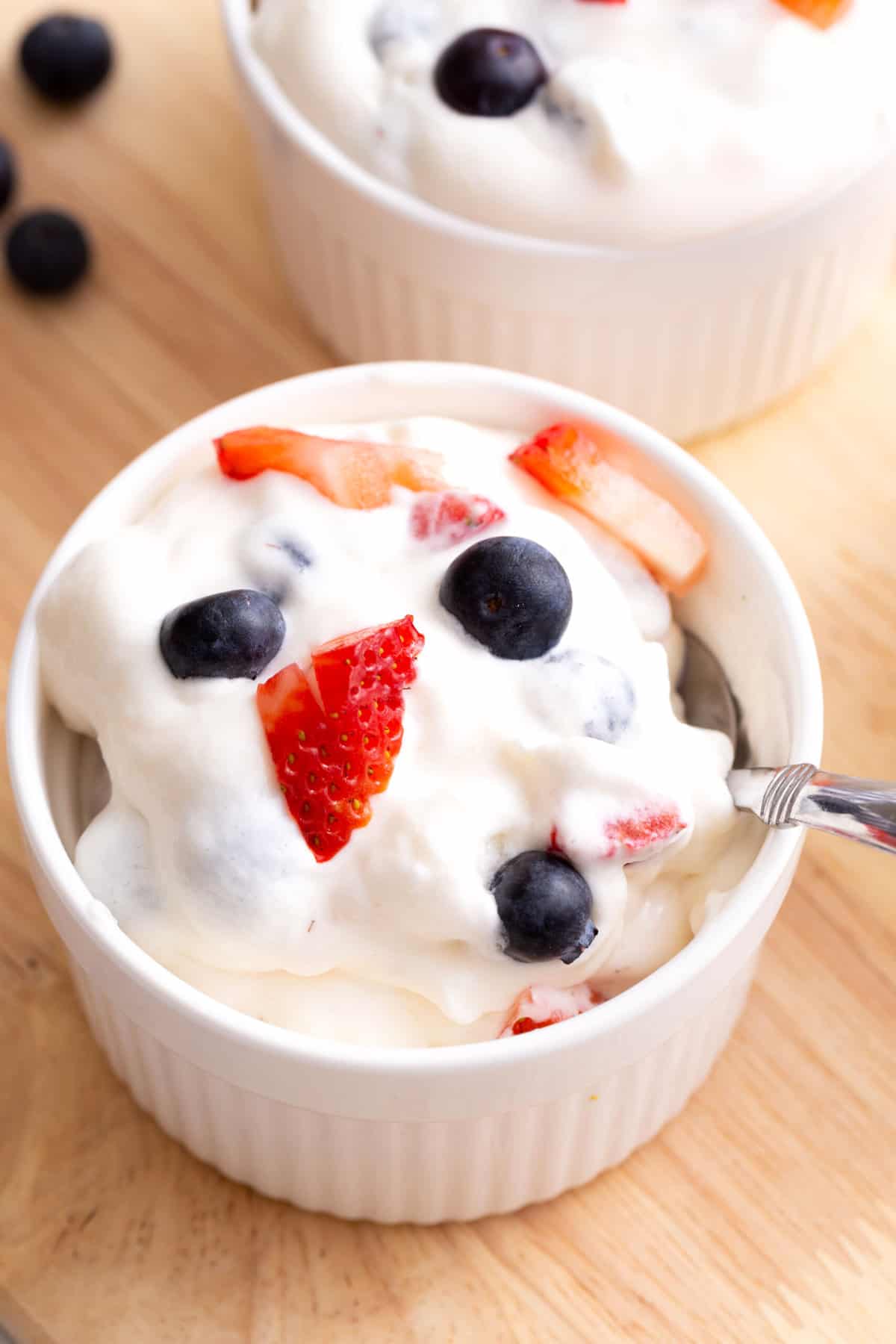 A bowl of red, white, and blue cheesecake dip.