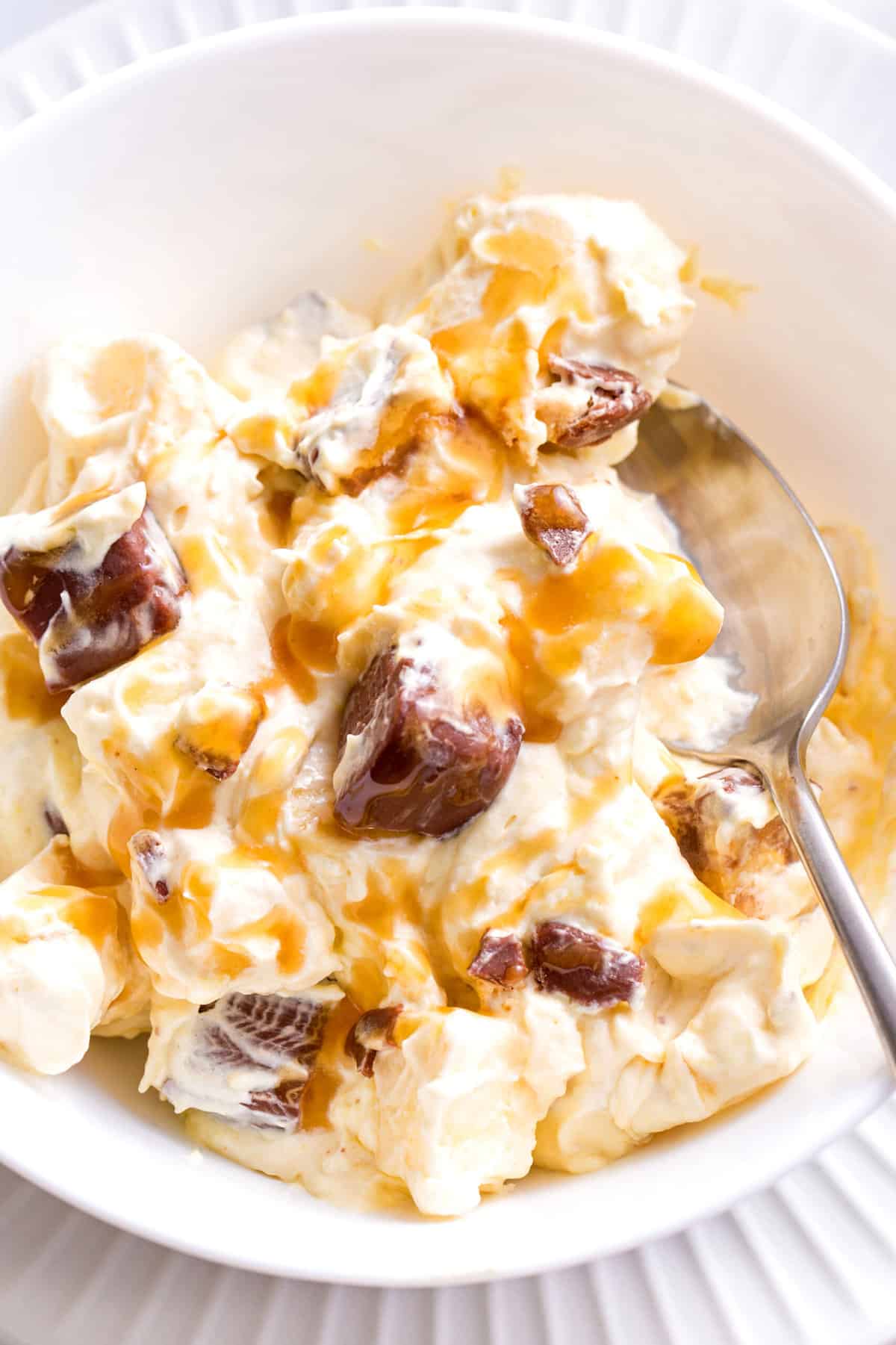 close up image of a bowl of snickers salad