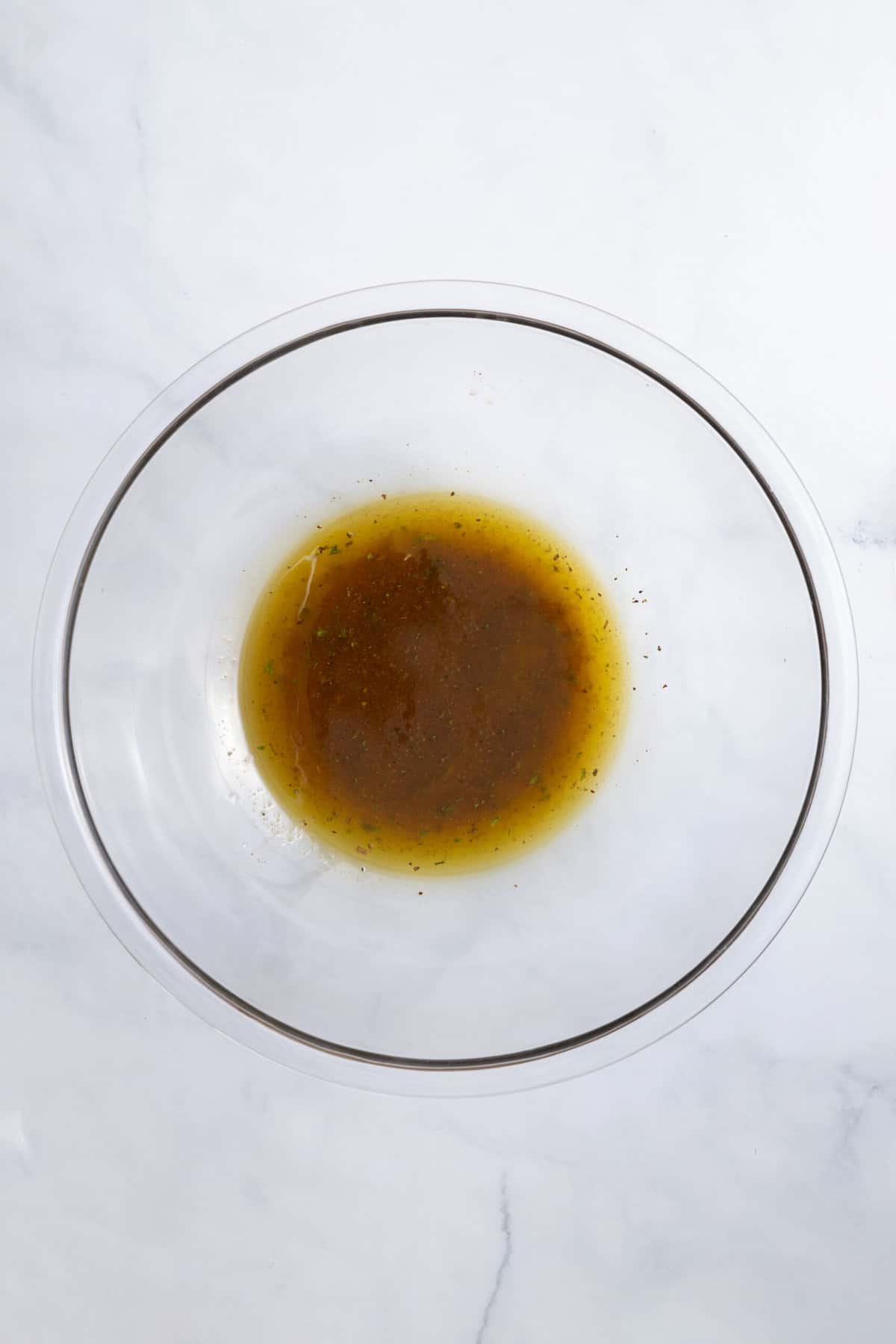 italian dressing sitting in a large glass bowl