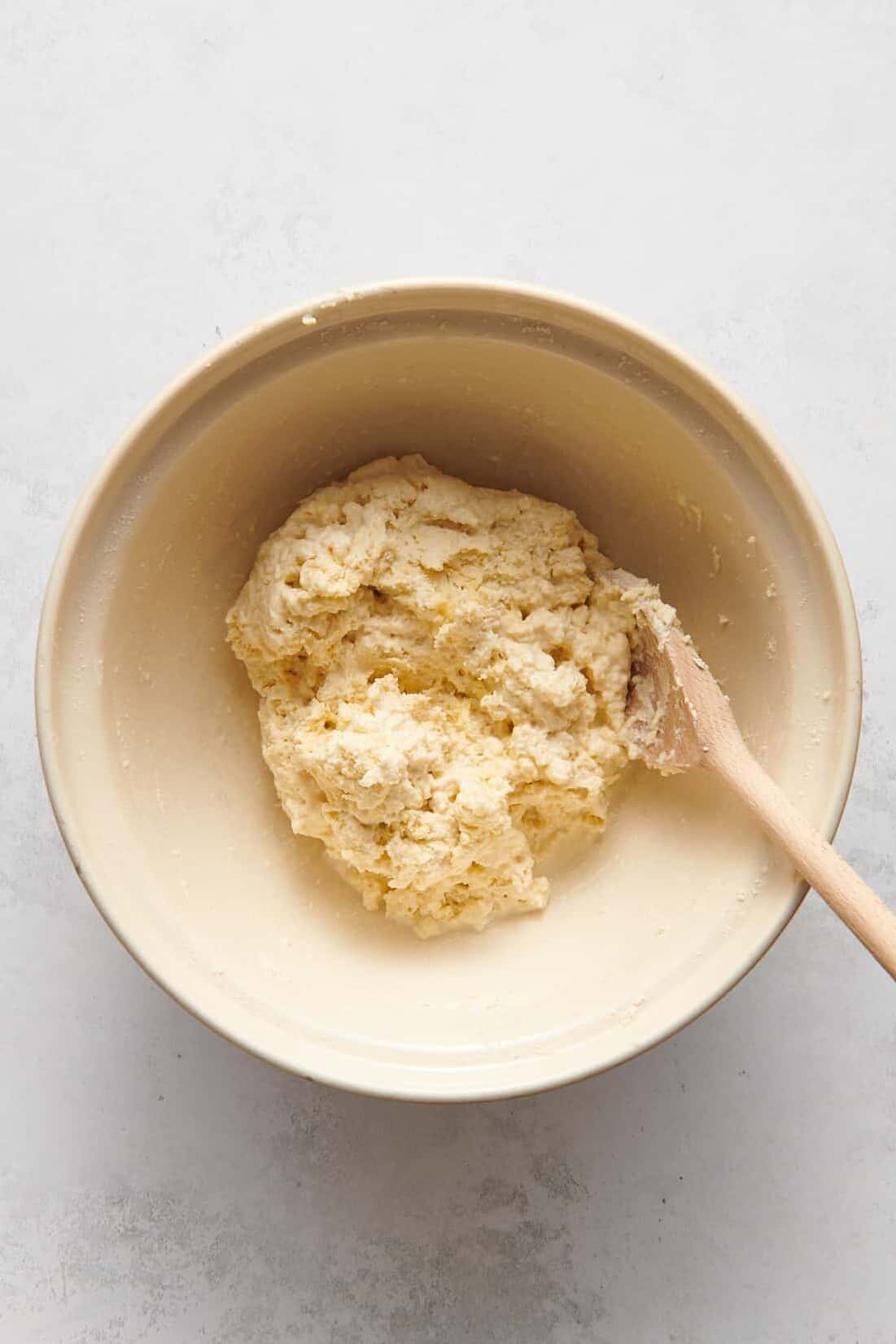 7up biscuit dough sitting in a large mixing bowl