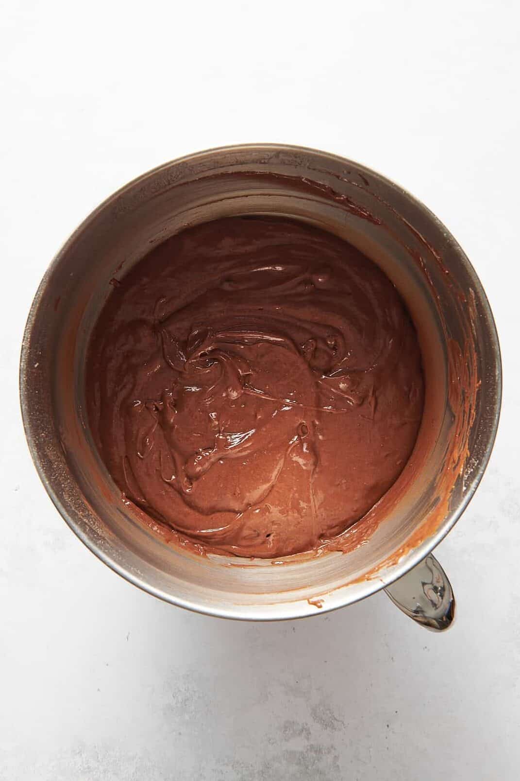 chocolate kahlua cake batter sitting in a stainless steel mixing