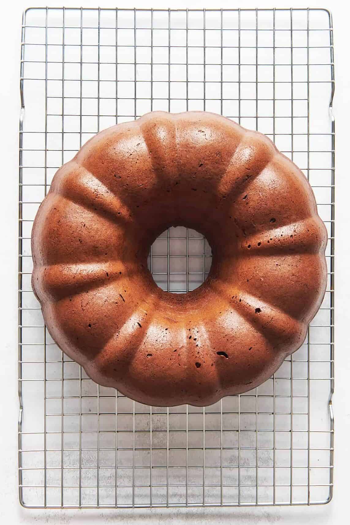 chocolate kahlua bundt cake sitting on a wire cooling rack