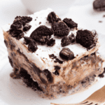 A slice of Oreo ice cream cake on a plate.